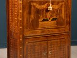 an old wooden cabinet with a bird on top of it