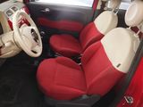 a red and white car with red seats and a steering wheel