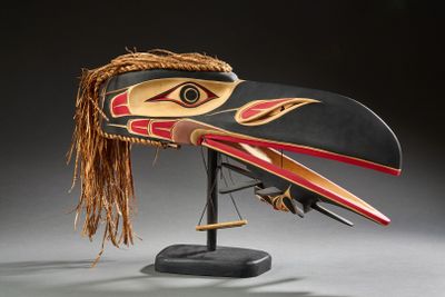 une image représentant un masque en bois orné d'une tête d'oiseau