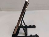 a cell phone sitting on a stand on a table