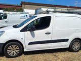 a white van parked in a lot with other vans in the background