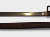 two different types of knives on a white surface