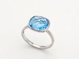 Gros plan sur une bague ornée d'une topaze bleue