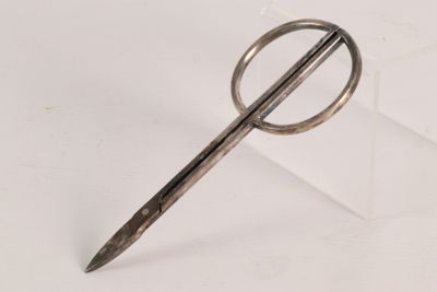 a pair of scissors sitting on top of a white surface