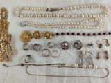 a lot of jewelry that is laying out on a table