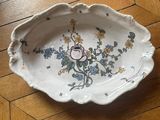 a white plate with flowers on it on a wooden floor