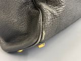 the inside of a black leather purse with gold hardware