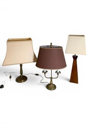 three lamps that are sitting on a white surface