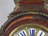 a close up of a clock with a decorative design on the face