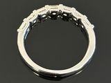 a close up of a diamond ring on a black surface