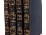 a set of four books sitting on top of each other