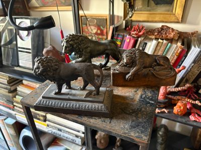 two statues of lions on a table in a room