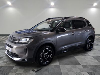 a grey suv parked on a checkered floor in a garage
