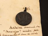 a piece of paper with writing on it and a coin on it