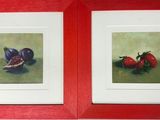 painting of two framed pictures of fruit on a green surface
