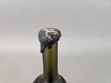 a close up of a bottle of wine with a bird on it