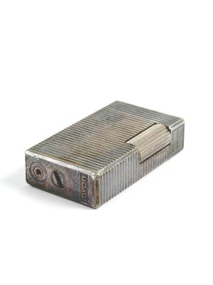 an image of a silver lighter sitting on top of a white surface