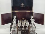 a wooden box with a set of wine glasses on it