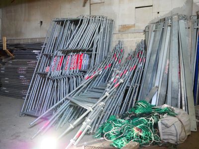 a pile of chairs and a pile of wires in a warehouse
