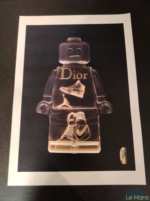 framed art print of a lego man with a pair of shoes in his hand