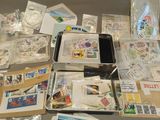 a lot of stamps and postcards sitting on a table