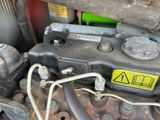 a close up of a car engine with a yellow sticker on it