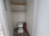 a toilet in the corner of a small room