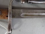 a close up of a knife with a wooden handle on a table