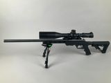 a rifle with a scope on a tripod on a white background