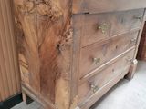 a wooden dresser with a marble top in a room