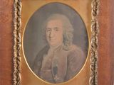 an old picture of a man in a suit and tie in a wooden frame