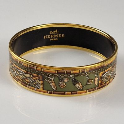 an image of a gold and green bracelet with a design on it