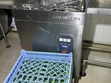 an image of a commercial kitchen with a dishwasher and trays
