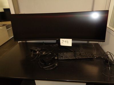 a computer desk with a monitor and keyboard on it