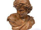 an antique bronze bust of a woman on a wooden base