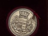 an image of a silver medal in a red case