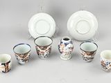 a group of cups and saucers sitting on a table