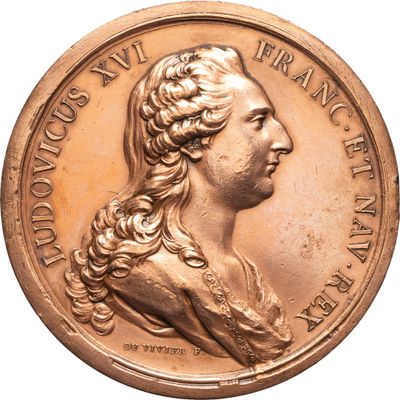 l'image d'une médaille d'or sur laquelle figure le visage d'une femme