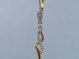 gold plated earrings with white and clear stones hanging from a branch