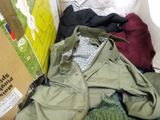 a pile of clothes and a box on the floor