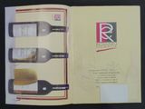 three bottles of wine in a book on a table