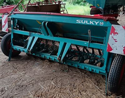 une photo d'un tracteur avec une remorque dans une grange