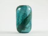a glass vase with a leaf design on it