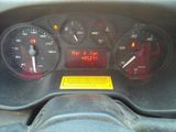a close up of the dashboard of a car with the time displayed
