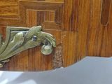 a close up of a wooden table with a drawer on it
