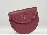 a small red purse with a monogram logo on the front