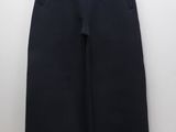 the children ' s black shorts are hanging on a hanger