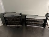 two electric heaters sitting on the floor next to each other