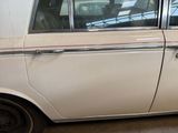 a white car with a red stripe parked in a garage
