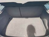 the back of a car with the trunk open and a shadow of a person in the back seat